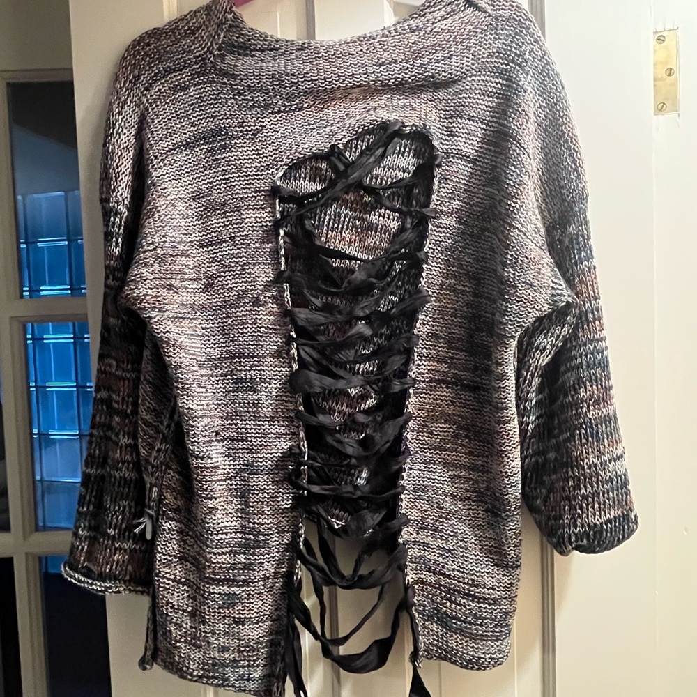 Edgy  Skifo sweater with back open with  ribbon never worn